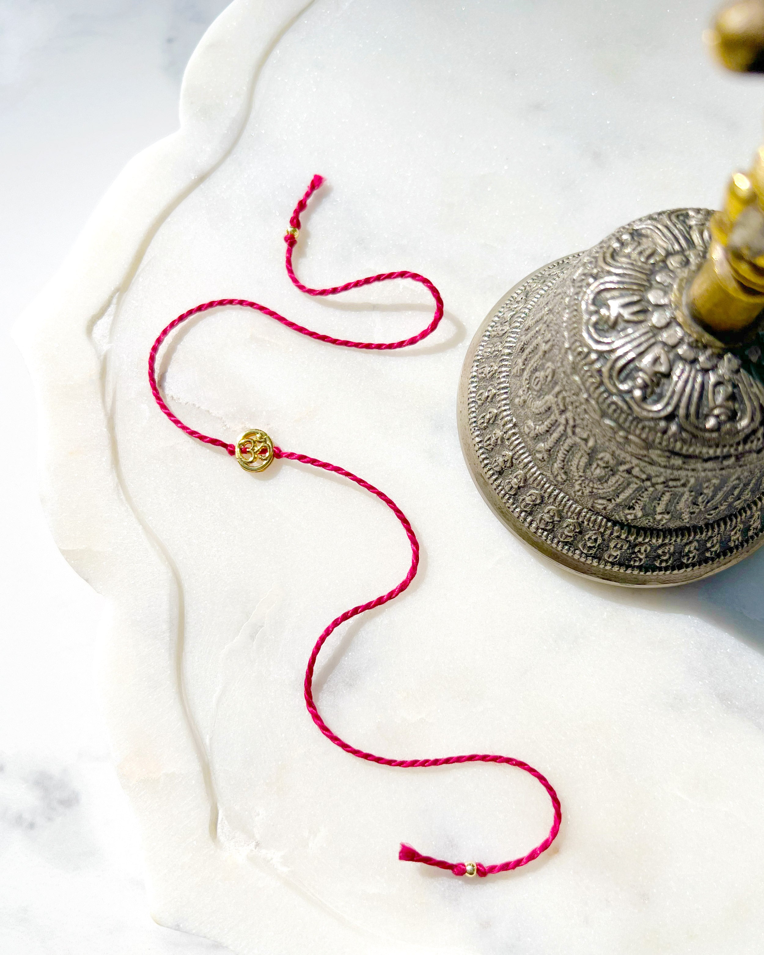 Gold Plated Oval Gold Plated Aum Rakhi
